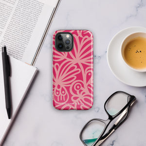 Introducing the Zafiro Rosa for iPhone by Statement Cases: a smartphone case featuring abstract floral and leaf patterns in various shades of pink. This dual-layer protection case combines an impact-resistant polycarbonate exterior with a TPU inner liner to ensure durability. The design showcases the brand name "Statement Cases" at the bottom, with precise cutouts revealing the phone’s camera lenses at the top left corner.