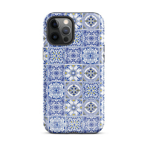 The Lisboa Azul for iPhone by Statement Cases is a smartphone adorned with a dual-layer protection phone case, featuring an intricate blue and white tile pattern. The design showcases various geometric and floral motifs, forming a visually appealing mosaic effect. The impact-resistant camera lenses and flash are prominently visible at the top left.