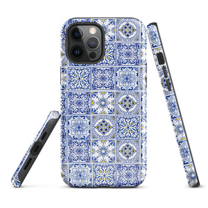 The Lisboa Azul for iPhone by Statement Cases is a smartphone adorned with a dual-layer protection phone case, featuring an intricate blue and white tile pattern. The design showcases various geometric and floral motifs, forming a visually appealing mosaic effect. The impact-resistant camera lenses and flash are prominently visible at the top left.