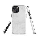 A protective iPhone case with a white marble-patterned design featuring three camera lenses and a flash. The marble pattern on this Marble Dreams for iPhone 15 Pro Max case is subtle, with light gray veining. The brand "Statement Cases" is subtly engraved at the bottom of the case.