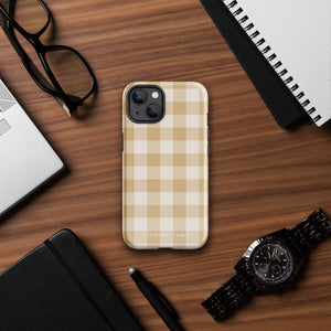 A Gingham Grace for iPhone by Statement Cases is covered with a protective case featuring a beige and white checkered pattern. The case's design includes a matte finish, dual-layer protection with an impact-resistant polycarbonate exterior and TPU lining, and the text "Statement Cases" printed near the bottom. The phone's cameras and buttons are visible.