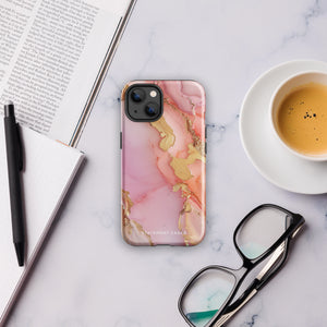 The Gold Blush Marble for iPhone showcases a glossy, marble-patterned case in shades of pink and gold. The decorative design features swirling patterns, seamlessly blending the colors. Crafted with impact-resistant polycarbonate for superior phone protection, "Statement Cases" is written in white at the bottom.