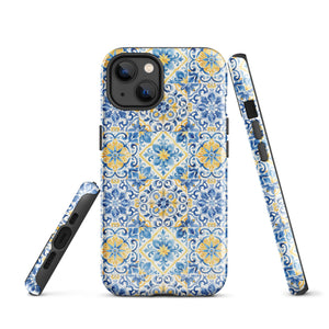 The Blue Mirage for iPhone by Statement Cases features a dual-layered, impact-resistant polycarbonate exterior with a TPU inner liner. Inspired by traditional Portuguese tiles, the blue and yellow patterned case boasts an intricate design of floral and geometric motifs. With its elegant and colorful appearance, the phone's camera is visible at the top left of the case.