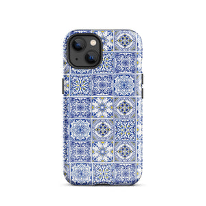 The Lisboa Azul for iPhone by Statement Cases is a smartphone adorned with a dual-layer protection phone case, featuring an intricate blue and white tile pattern. The design showcases various geometric and floral motifs, forming a visually appealing mosaic effect. The impact-resistant camera lenses and flash are prominently visible at the top left.