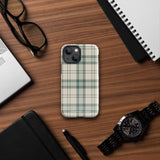 A smartphone with a beige and green plaid-patterned, impact-resistant polycarbonate case is shown. The phone’s rear camera lenses are prominently visible at the top left. The durable phone case features the words “Statement Cases” printed in small text at the bottom center. This is the Elegant Plaid for iPhone.