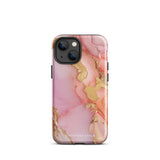 The Gold Blush Marble for iPhone showcases a glossy, marble-patterned case in shades of pink and gold. The decorative design features swirling patterns, seamlessly blending the colors. Crafted with impact-resistant polycarbonate for superior phone protection, "Statement Cases" is written in white at the bottom.