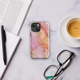 The Gold Blush Marble for iPhone showcases a glossy, marble-patterned case in shades of pink and gold. The decorative design features swirling patterns, seamlessly blending the colors. Crafted with impact-resistant polycarbonate for superior phone protection, "Statement Cases" is written in white at the bottom.