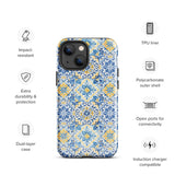 The Blue Mirage for iPhone by Statement Cases features a dual-layered, impact-resistant polycarbonate exterior with a TPU inner liner. Inspired by traditional Portuguese tiles, the blue and yellow patterned case boasts an intricate design of floral and geometric motifs. With its elegant and colorful appearance, the phone's camera is visible at the top left of the case.