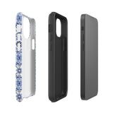 The Lisboa Azul for iPhone by Statement Cases is a smartphone adorned with a dual-layer protection phone case, featuring an intricate blue and white tile pattern. The design showcases various geometric and floral motifs, forming a visually appealing mosaic effect. The impact-resistant camera lenses and flash are prominently visible at the top left.