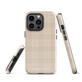 A smartphone with a plaid design case is displayed. The durable phone case features a beige and light brown checked pattern. The phone's camera lenses are visible at the top left corner. With dual-layer protection, the bottom of the impact-resistant polycarbonate Sophisticated Plaid for iPhone case reads "Statement Cases" in white.