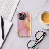 The Gold Blush Marble for iPhone showcases a glossy, marble-patterned case in shades of pink and gold. The decorative design features swirling patterns, seamlessly blending the colors. Crafted with impact-resistant polycarbonate for superior phone protection, "Statement Cases" is written in white at the bottom.