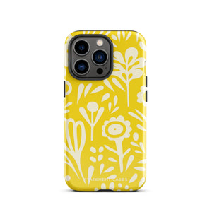 The Sol Dorado for iPhone by Statement Cases is a smartphone with a yellow case featuring a white, abstract floral and plant pattern. The camera lenses are prominent in the top left corner of the device. With dual-layer protection and impact-resistant TPU lining, "Statement Cases" is printed at the bottom of the case.