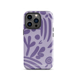 The Luna Morada for iPhone by Statement Cases is a durable phone case with a purple protective exterior featuring abstract dark purple and lavender patterns. The design includes geometric shapes and curves, giving it a modern artistic look. Made from impact-resistant polycarbonate, the lower part of the case prominently displays "STATEMENT CASES.