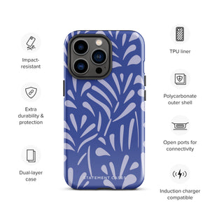 An iPhone encased in the "Mariposa Azul" by Statement Cases, featuring a blue design with an abstract white leaf pattern. The case combines curved and pointed shapes and provides dual-layer protection with TPU lining and impact-resistant polycarbonate. Camera lenses and other top elements remain unobstructed, and "Statement Cases" is inscribed at the bottom.