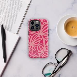 Introducing the Zafiro Rosa for iPhone by Statement Cases: a smartphone case featuring abstract floral and leaf patterns in various shades of pink. This dual-layer protection case combines an impact-resistant polycarbonate exterior with a TPU inner liner to ensure durability. The design showcases the brand name "Statement Cases" at the bottom, with precise cutouts revealing the phone’s camera lenses at the top left corner.