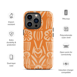 A Savannah Ardiente for iPhone from Statement Cases, featuring a dual-layered phone case in orange with a floral pattern showcasing cream-colored flowers, leaves, and geometric shapes. This impact-resistant polycarbonate case displays "STATEMENT CASES" at the bottom and reveals the camera lenses at the top left corner.