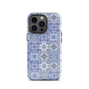 The Lisboa Azul for iPhone by Statement Cases is a smartphone adorned with a dual-layer protection phone case, featuring an intricate blue and white tile pattern. The design showcases various geometric and floral motifs, forming a visually appealing mosaic effect. The impact-resistant camera lenses and flash are prominently visible at the top left.