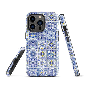 The Lisboa Azul for iPhone by Statement Cases is a smartphone adorned with a dual-layer protection phone case, featuring an intricate blue and white tile pattern. The design showcases various geometric and floral motifs, forming a visually appealing mosaic effect. The impact-resistant camera lenses and flash are prominently visible at the top left.