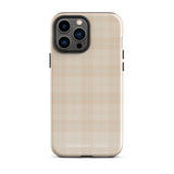 A smartphone with a plaid design case is displayed. The durable phone case features a beige and light brown checked pattern. The phone's camera lenses are visible at the top left corner. With dual-layer protection, the bottom of the impact-resistant polycarbonate Sophisticated Plaid for iPhone case reads "Statement Cases" in white.