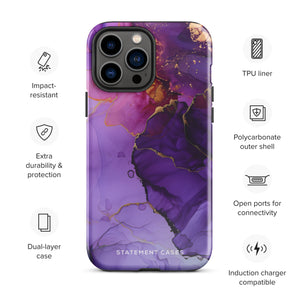 A Statement Cases Golden Orchid Marble for iPhone with a case featuring an abstract design of swirling purple, pink, and gold hues over a white background. The marbled patterns with metallic accents provide dual-layer protection and are impact-resistant. The top of the case has cutouts for the phone's camera lenses and is induction charging compatible.