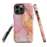 The Gold Blush Marble for iPhone showcases a glossy, marble-patterned case in shades of pink and gold. The decorative design features swirling patterns, seamlessly blending the colors. Crafted with impact-resistant polycarbonate for superior phone protection, "Statement Cases" is written in white at the bottom.