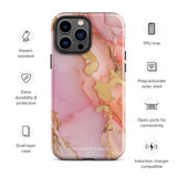 The Gold Blush Marble for iPhone showcases a glossy, marble-patterned case in shades of pink and gold. The decorative design features swirling patterns, seamlessly blending the colors. Crafted with impact-resistant polycarbonate for superior phone protection, "Statement Cases" is written in white at the bottom.