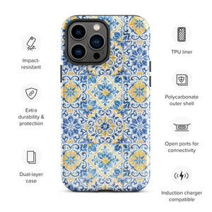 The Blue Mirage for iPhone by Statement Cases features a dual-layered, impact-resistant polycarbonate exterior with a TPU inner liner. Inspired by traditional Portuguese tiles, the blue and yellow patterned case boasts an intricate design of floral and geometric motifs. With its elegant and colorful appearance, the phone's camera is visible at the top left of the case.