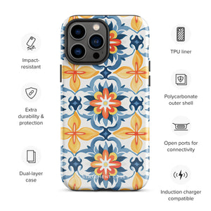 Statement Cases' Mediterranean Bloom for iPhone is showcased, featuring an intricate, colorful pattern. The design includes blue, yellow, and orange floral shapes in a symmetrical arrangement on a light blue background. This durable phone case provides dual-layer protection and is constructed from impact-resistant polycarbonate to safeguard your device.