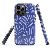 An iPhone encased in the "Mariposa Azul" by Statement Cases, featuring a blue design with an abstract white leaf pattern. The case combines curved and pointed shapes and provides dual-layer protection with TPU lining and impact-resistant polycarbonate. Camera lenses and other top elements remain unobstructed, and "Statement Cases" is inscribed at the bottom.