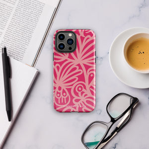 Introducing the Zafiro Rosa for iPhone by Statement Cases: a smartphone case featuring abstract floral and leaf patterns in various shades of pink. This dual-layer protection case combines an impact-resistant polycarbonate exterior with a TPU inner liner to ensure durability. The design showcases the brand name "Statement Cases" at the bottom, with precise cutouts revealing the phone’s camera lenses at the top left corner.