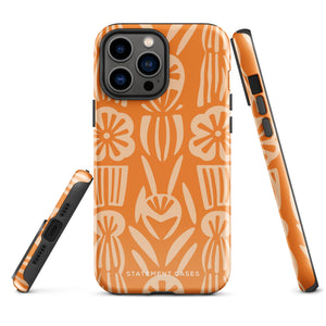 A Savannah Ardiente for iPhone from Statement Cases, featuring a dual-layered phone case in orange with a floral pattern showcasing cream-colored flowers, leaves, and geometric shapes. This impact-resistant polycarbonate case displays "STATEMENT CASES" at the bottom and reveals the camera lenses at the top left corner.