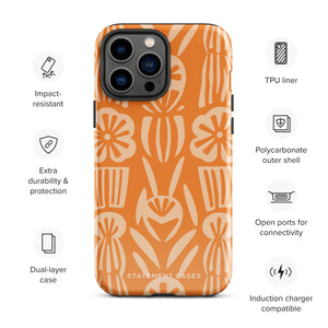 A Savannah Ardiente for iPhone from Statement Cases, featuring a dual-layered phone case in orange with a floral pattern showcasing cream-colored flowers, leaves, and geometric shapes. This impact-resistant polycarbonate case displays "STATEMENT CASES" at the bottom and reveals the camera lenses at the top left corner.