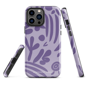 The Luna Morada for iPhone by Statement Cases is a durable phone case with a purple protective exterior featuring abstract dark purple and lavender patterns. The design includes geometric shapes and curves, giving it a modern artistic look. Made from impact-resistant polycarbonate, the lower part of the case prominently displays "STATEMENT CASES.