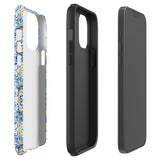 The Blue Mirage for iPhone by Statement Cases features a dual-layered, impact-resistant polycarbonate exterior with a TPU inner liner. Inspired by traditional Portuguese tiles, the blue and yellow patterned case boasts an intricate design of floral and geometric motifs. With its elegant and colorful appearance, the phone's camera is visible at the top left of the case.