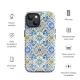 The Blue Mirage for iPhone by Statement Cases features a dual-layered, impact-resistant polycarbonate exterior with a TPU inner liner. Inspired by traditional Portuguese tiles, the blue and yellow patterned case boasts an intricate design of floral and geometric motifs. With its elegant and colorful appearance, the phone's camera is visible at the top left of the case.