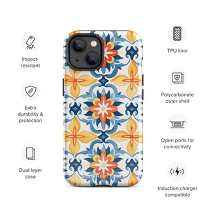 Statement Cases' Mediterranean Bloom for iPhone is showcased, featuring an intricate, colorful pattern. The design includes blue, yellow, and orange floral shapes in a symmetrical arrangement on a light blue background. This durable phone case provides dual-layer protection and is constructed from impact-resistant polycarbonate to safeguard your device.