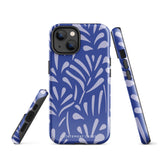 An iPhone encased in the "Mariposa Azul" by Statement Cases, featuring a blue design with an abstract white leaf pattern. The case combines curved and pointed shapes and provides dual-layer protection with TPU lining and impact-resistant polycarbonate. Camera lenses and other top elements remain unobstructed, and "Statement Cases" is inscribed at the bottom.