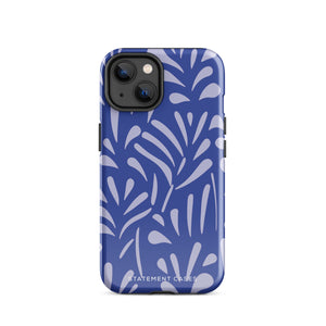 An iPhone encased in the "Mariposa Azul" by Statement Cases, featuring a blue design with an abstract white leaf pattern. The case combines curved and pointed shapes and provides dual-layer protection with TPU lining and impact-resistant polycarbonate. Camera lenses and other top elements remain unobstructed, and "Statement Cases" is inscribed at the bottom.