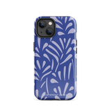 An iPhone encased in the "Mariposa Azul" by Statement Cases, featuring a blue design with an abstract white leaf pattern. The case combines curved and pointed shapes and provides dual-layer protection with TPU lining and impact-resistant polycarbonate. Camera lenses and other top elements remain unobstructed, and "Statement Cases" is inscribed at the bottom.