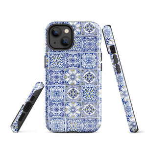 The Lisboa Azul for iPhone by Statement Cases is a smartphone adorned with a dual-layer protection phone case, featuring an intricate blue and white tile pattern. The design showcases various geometric and floral motifs, forming a visually appealing mosaic effect. The impact-resistant camera lenses and flash are prominently visible at the top left.