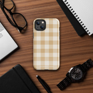 A Gingham Grace for iPhone by Statement Cases is covered with a protective case featuring a beige and white checkered pattern. The case's design includes a matte finish, dual-layer protection with an impact-resistant polycarbonate exterior and TPU lining, and the text "Statement Cases" printed near the bottom. The phone's cameras and buttons are visible.