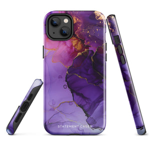 A Statement Cases Golden Orchid Marble for iPhone with a case featuring an abstract design of swirling purple, pink, and gold hues over a white background. The marbled patterns with metallic accents provide dual-layer protection and are impact-resistant. The top of the case has cutouts for the phone's camera lenses and is induction charging compatible.