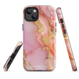 The Gold Blush Marble for iPhone showcases a glossy, marble-patterned case in shades of pink and gold. The decorative design features swirling patterns, seamlessly blending the colors. Crafted with impact-resistant polycarbonate for superior phone protection, "Statement Cases" is written in white at the bottom.