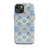 The Blue Mirage for iPhone by Statement Cases features a dual-layered, impact-resistant polycarbonate exterior with a TPU inner liner. Inspired by traditional Portuguese tiles, the blue and yellow patterned case boasts an intricate design of floral and geometric motifs. With its elegant and colorful appearance, the phone's camera is visible at the top left of the case.