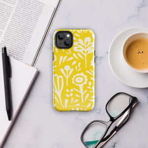 The Sol Dorado for iPhone by Statement Cases is a smartphone with a yellow case featuring a white, abstract floral and plant pattern. The camera lenses are prominent in the top left corner of the device. With dual-layer protection and impact-resistant TPU lining, "Statement Cases" is printed at the bottom of the case.