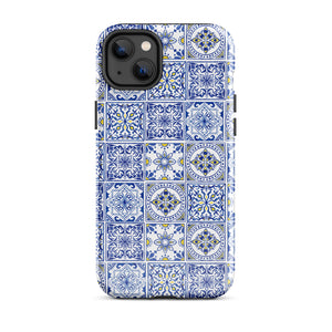 The Lisboa Azul for iPhone by Statement Cases is a smartphone adorned with a dual-layer protection phone case, featuring an intricate blue and white tile pattern. The design showcases various geometric and floral motifs, forming a visually appealing mosaic effect. The impact-resistant camera lenses and flash are prominently visible at the top left.