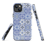 The Lisboa Azul for iPhone by Statement Cases is a smartphone adorned with a dual-layer protection phone case, featuring an intricate blue and white tile pattern. The design showcases various geometric and floral motifs, forming a visually appealing mosaic effect. The impact-resistant camera lenses and flash are prominently visible at the top left.