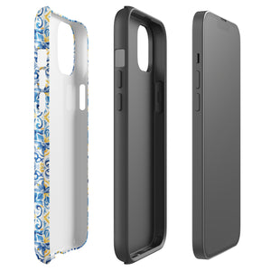 The Blue Mirage for iPhone by Statement Cases features a dual-layered, impact-resistant polycarbonate exterior with a TPU inner liner. Inspired by traditional Portuguese tiles, the blue and yellow patterned case boasts an intricate design of floral and geometric motifs. With its elegant and colorful appearance, the phone's camera is visible at the top left of the case.