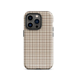 A smartphone with a brown and beige houndstooth-patterned case is shown from the back. The impact-resistant, dual-layered Classic Houndstooth for iPhone by Statement Cases protects the phone's body and leaves openings for the camera lenses and flash. The hues give the case a stylish and sophisticated appearance.