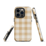 A Gingham Grace for iPhone by Statement Cases is covered with a protective case featuring a beige and white checkered pattern. The case's design includes a matte finish, dual-layer protection with an impact-resistant polycarbonate exterior and TPU lining, and the text "Statement Cases" printed near the bottom. The phone's cameras and buttons are visible.